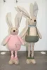 Two decorative Easter bunnies standing against a plain wall. Voir les images du produit