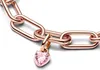 A close-up shot of a rose gold bracelet with a pink heart-shaped charm. Produktbild-Vorschau