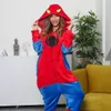 A woman wearing a Spiderman costume stands in a room with furniture and decorations. Anteprima dell’immagine prodotto