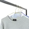 A close-up view of clothing items hanging on a rack. Produktbild-Vorschau