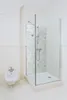 A clean, modern bathroom with a glass shower enclosure and a bidet. Produktbild-Vorschau