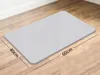 A gray diatomite bath mat is shown on a wooden floor. Podgląd zdjęcia produktu