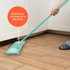 A person is using a mint-colored floor mop to clean a wooden floor next to white cabinets. Produktbild-Vorschau