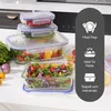 A collection of glass food storage containers filled with various fresh ingredients, arranged on a kitchen countertop. Anteprima dell’immagine prodotto