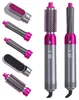 Silberne und magentafarbene 5-in-1 Haarstylingbürste mit mehreren Aufsätzen, darunter Rundbürste, Lockenstäbe, Paddelbürste und Föhn zum Vorstylen Voir les images du produit