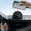 A hand is placing a smartphone with navigation on a car dashboard mount. Náhled obrázku produktu