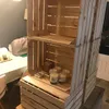 Wooden crates stacked on top of each other, with some candles and wax melts displayed on the shelves. Náhled obrázku produktu
