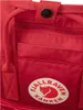 A close-up view of a red Fjällräven Kånken backpack, showing the brand logo and some of the exterior pockets and straps. Produktbild-Vorschau