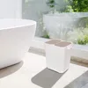 A white dual-compartment trash can sits next to a white bathtub in a bright, sunlit bathroom. Náhľad obrázku produktu