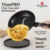 A hand holding a non-stick frying pan with an omelet being slid onto a plate. Anteprima dell’immagine prodotto