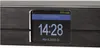 A close-up view of a digital radio's display screen showing the time, date, and radio station information. Produktbild-Vorschau