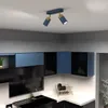 A modern kitchen with blue and black cabinets, a sink, and a ceiling light fixture. Podgląd zdjęcia produktu