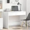 A white desk with a laptop, books, and a lamp on it, with a chair next to it. Anteprima dell’immagine prodotto