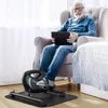 An elderly man sits in a chair using a mini-exercise bike while holding a tablet and wearing headphones. Náhľad obrázku produktu