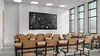 An empty classroom with desks and chairs facing a blackboard. Náhled obrázku produktu