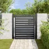 A black metal garden gate with horizontal slats, set between two stone pillars, with a paved walkway leading up to it and greenery surrounding it. Produktbild-Vorschau