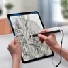 A person is drawing on a tablet with a stylus. The drawing on the tablet is a sketch of a house and a tree. Anteprima dell’immagine prodotto
