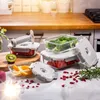 A set of glass vacuum food storage containers filled with food items like broccoli, strawberries, and fruit, arranged on a kitchen counter. Anteprima dell’immagine prodotto