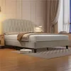A beige upholstered bed with a tufted headboard is shown in a bedroom setting. Podgląd zdjęcia produktu