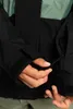 Close-up of a person's hands adjusting a zipper on a jacket. Náhled obrázku produktu