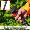 A hand holding the handle of a garden tool, with green foliage in the background. Produktbild-Vorschau