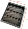 A dark gray plastic insert with multiple parallel ridges, designed to hold items. Produktbild-Vorschau