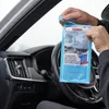 A person is holding a package of SONAX microfibre cloths inside a car. Náhled obrázku produktu