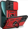 A red and black phone case with a camera cover and a ring holder, shown from multiple angles. Produktbild-Vorschau