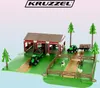 A toy farm playset with tractors, a barn, trees, fences, and farm animals. Produktbild-Vorschau