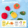 A collection of plush fruit and vegetable toys floating in water, with marketing text and comparison graphics at the bottom. Produktbild-Vorschau