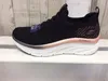 A side view of a black Skechers sneaker with a white sole and rose gold accents. Náhled obrázku produktu