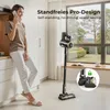 A woman is on the phone in a kitchen, with a cordless vacuum cleaner standing nearby. Náhled obrázku produktu