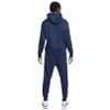 A person wearing a navy blue Nike tracksuit, viewed from the back. Produktbild-Vorschau