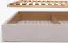 A close-up view of a bed frame and its wooden slats, showing the construction and storage space. Náhled obrázku produktu