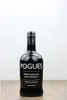 A bottle of The Pogues Irish Whiskey is centered on a wooden surface against a white background. Produktbild-Vorschau
