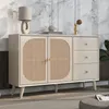 A sideboard with rattan doors and drawers, placed in a room with a marble-patterned wall and a rug. Voir les images du produit