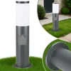 A close-up and a lifestyle shot of a modern outdoor lamp post with an integrated electrical outlet, set against a grassy lawn and a house entrance. Produktbild-Vorschau