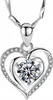 A close-up studio shot of a silver heart-shaped pendant necklace with a large clear gemstone in the center, surrounded by smaller clear gemstones. Anteprima dell’immagine prodotto