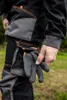 A person wearing work pants and holding a glove. Produktbild-Vorschau