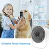 A young girl is petting a golden retriever next to a white fan. There are icons and text describing the fan's features. Produktbild-Vorschau