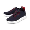 A pair of navy blue Geox sneakers with red accents and white soles are displayed on a white background. Produktbild-Vorschau