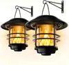 Two solar-powered lanterns with flickering flame effects are mounted on wall brackets. Produktbild-Vorschau