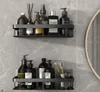 Two black shower shelves mounted on a gray tiled wall, filled with various toiletries and bathroom accessories. Produktbild-Vorschau
