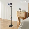 A projector stand with a projector on it, next to a nightstand in a bedroom. Podgląd zdjęcia produktu