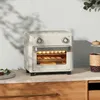 A cream-colored mini oven with food inside, placed on a kitchen counter. Produktbild-Vorschau