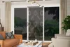 A living room with a sliding glass door that has a beaded curtain. Produktbild-Vorschau