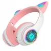 A pair of pink and white cat-ear headphones with RGB LED lights. Náhľad obrázku produktu