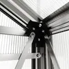 A close-up view of the corner joint of a greenhouse structure, showing the metal frame and polycarbonate panels. Produktbild-Vorschau