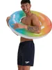 A man wearing swim trunks and holding an inflatable tube. Produktbild-Vorschau