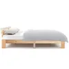 A side view of a wooden bed frame with a mattress and pillows. Náhled obrázku produktu